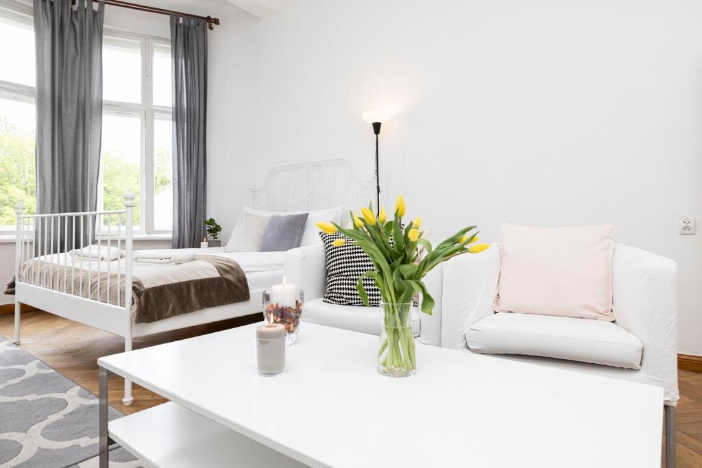 sala de estar con muebles blancos y mesa blanca en Baltic Rooms Sopot, en Sopot