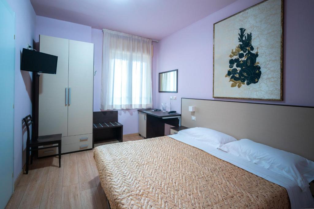 Łóżko lub łóżka w pokoju w obiekcie L'Anfora
