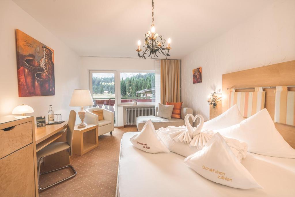 A bed or beds in a room at Alpenhotel DAS KÜREN