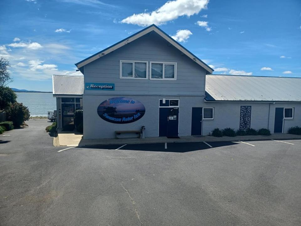 a building with a sign on the side of it at Swansea Motor Inn Tasmania in Swansea