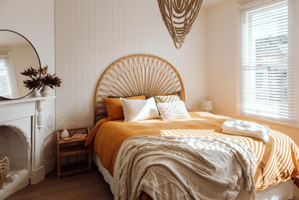 a bedroom with a large bed with a wooden headboard at Sweet Home Alexander in Burnie