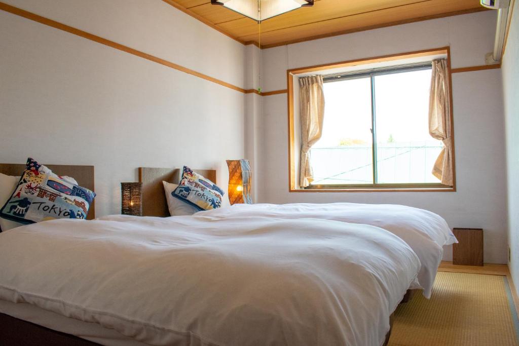 Postel nebo postele na pokoji v ubytování T Square Hakuba