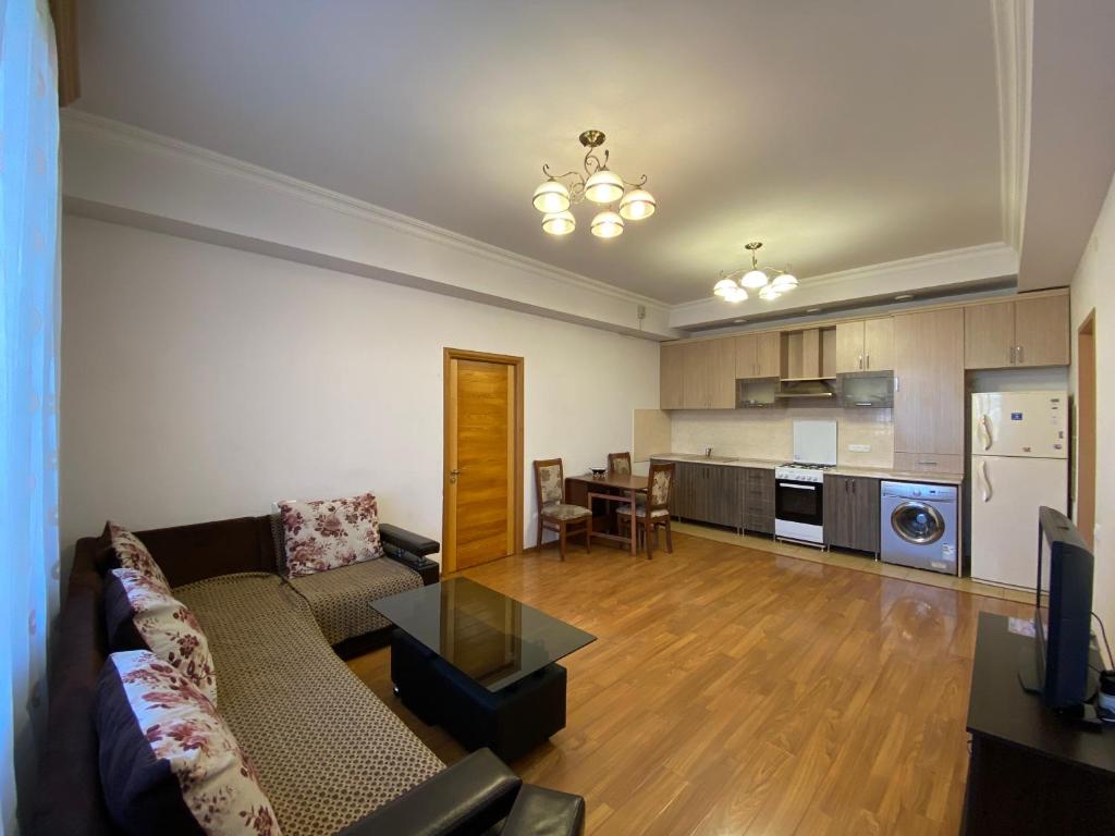 a living room with a couch and a table and a kitchen at Argishti street 2 bedroom Elegance apartment with balcony GL152 in Yerevan