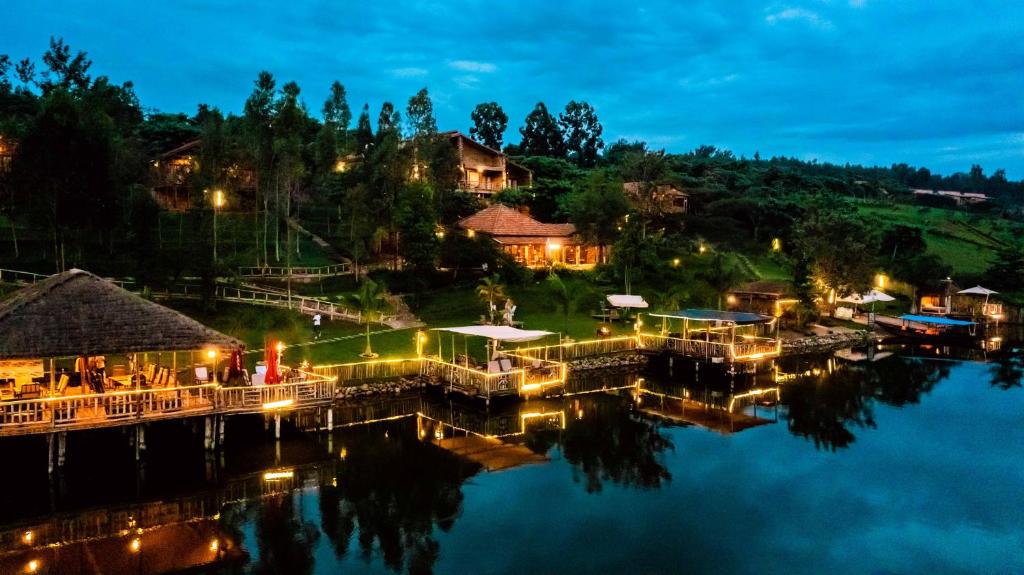a resort on the water at night at Vintage Cottage in Rwamagana
