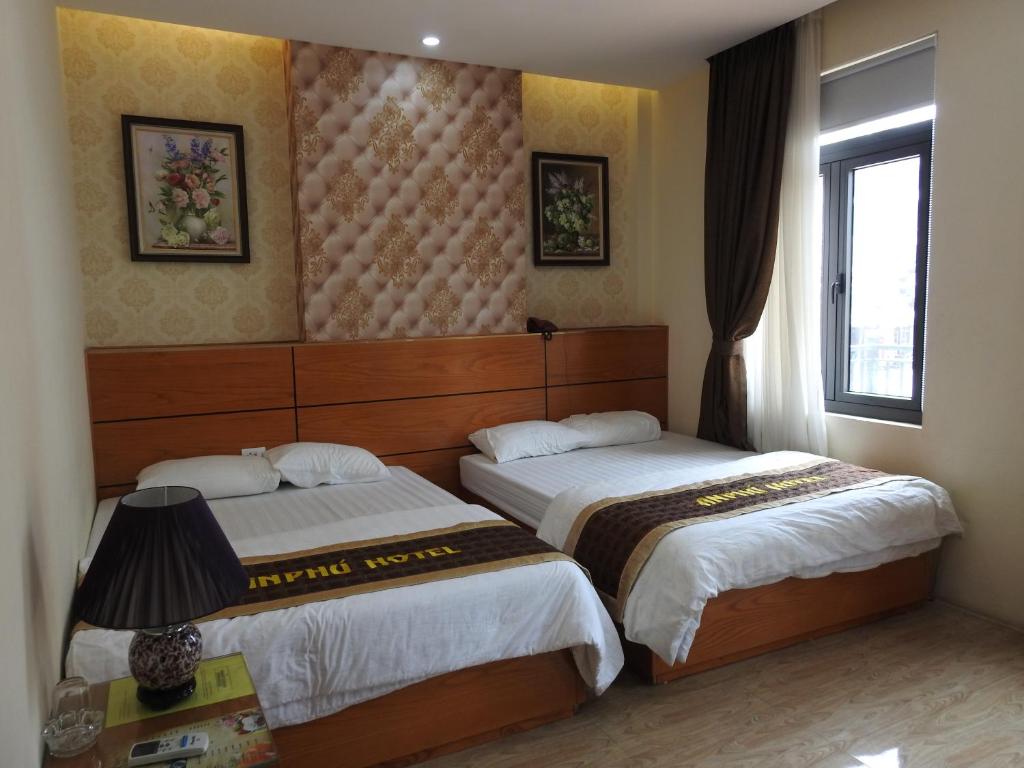 Postel nebo postele na pokoji v ubytování An Phú Nguyễn Hoàng Hotel