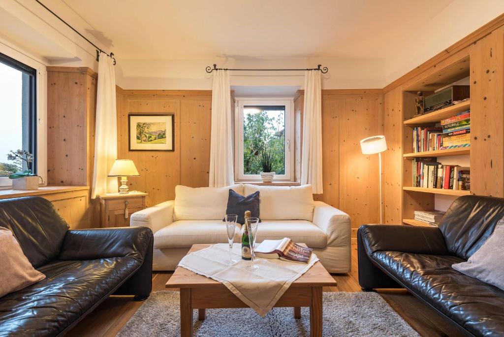 a living room with two leather couches and a table at Appartement Rosa Seis in Siusi
