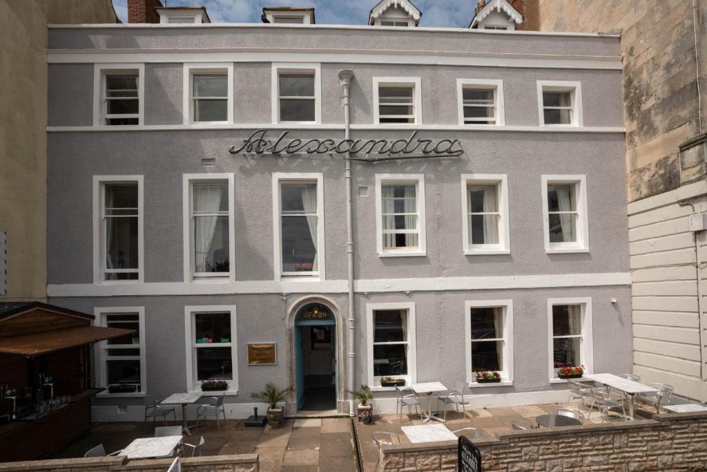 a large white building with a sign on it at Alexandra Hotel in Weymouth