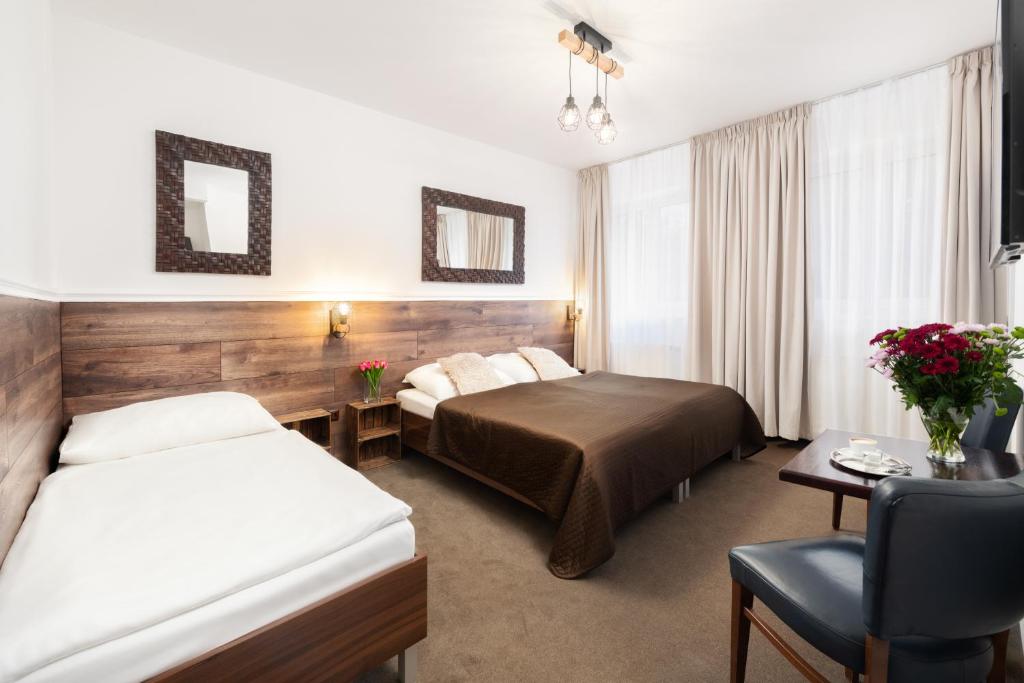 Postel nebo postele na pokoji v ubytování Hotel U Šuláka