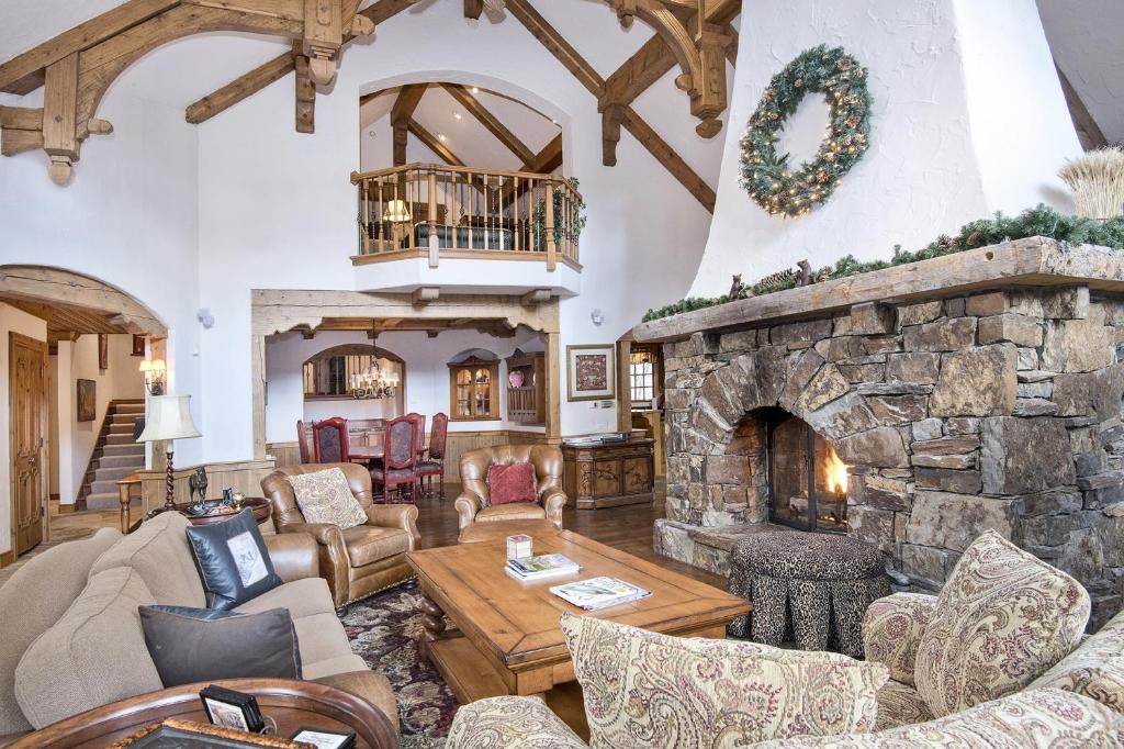 a large living room with a stone fireplace at 349 Holden Rd, home in Beaver Creek
