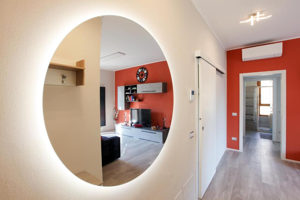 een woonkamer met een ovale spiegel aan de muur bij DADA 2bd App - nuovo in CENTRO zona Navigli in Milaan