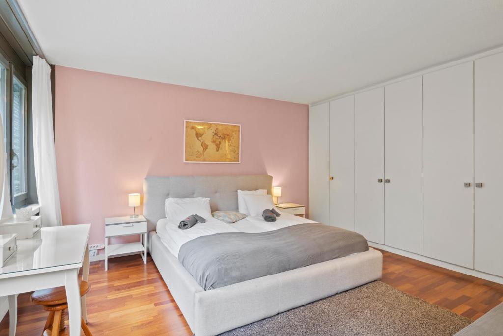 a bedroom with a large bed and a desk at Large, central, bright flat in Luzern