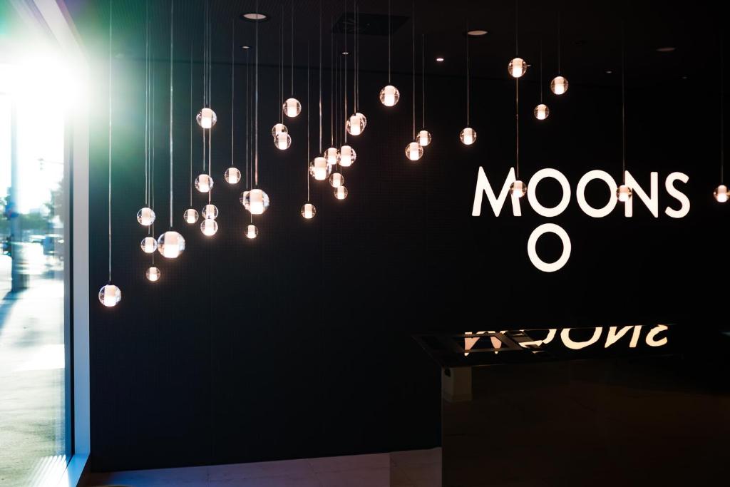 a store window with a sign that reads mons at MOOONS Vienna in Vienna