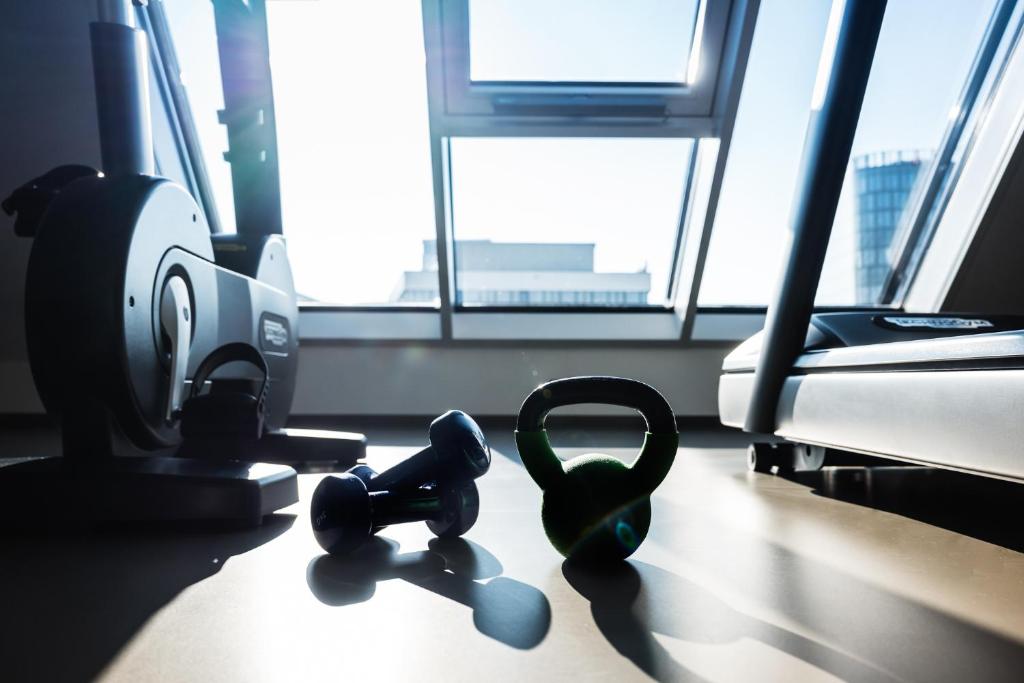 two pairs of dumbbells sitting on a floor in a room at MOOONS Vienna in Vienna