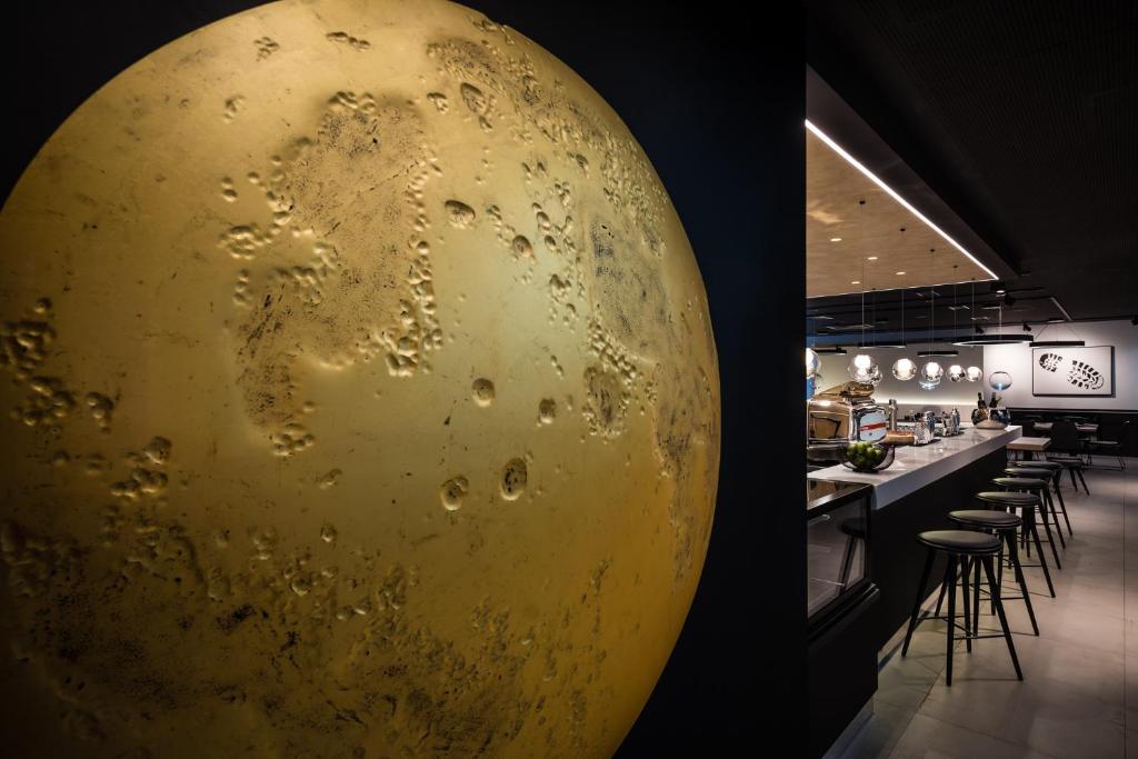 a large gold object on the wall of a restaurant at MOOONS Vienna in Vienna