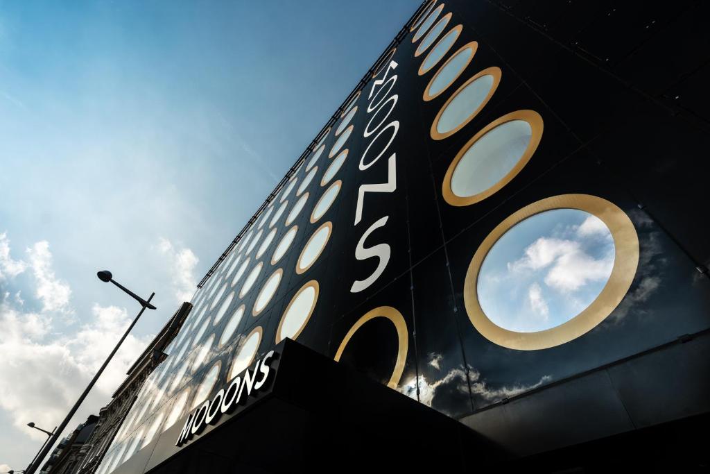 a black and gold sign on the side of a building at MOOONS Vienna in Vienna