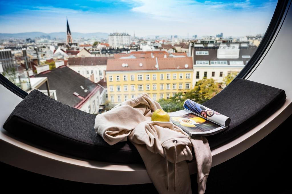 a window with a view of a city at MOOONS Vienna in Vienna