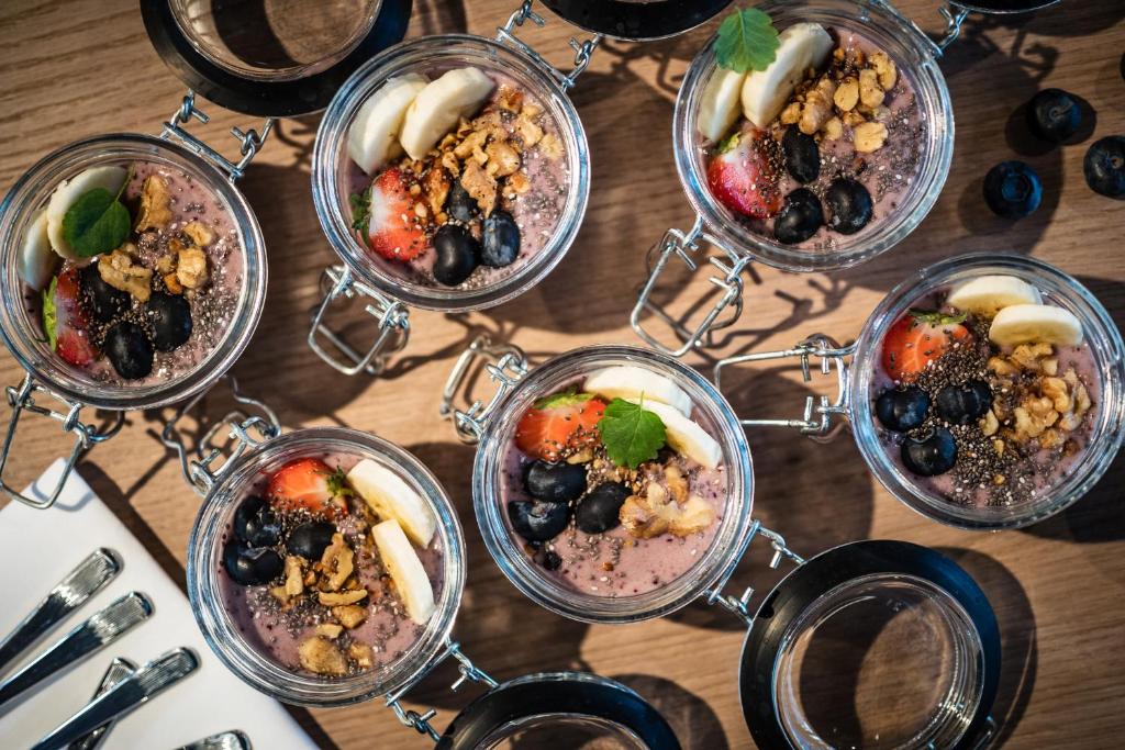a table topped with different types of food in glasses at MOOONS Vienna in Vienna