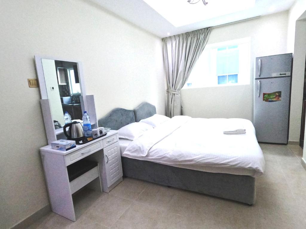 a hotel room with a bed and a mirror at Barsha Star Residence - Home Stay in Dubai