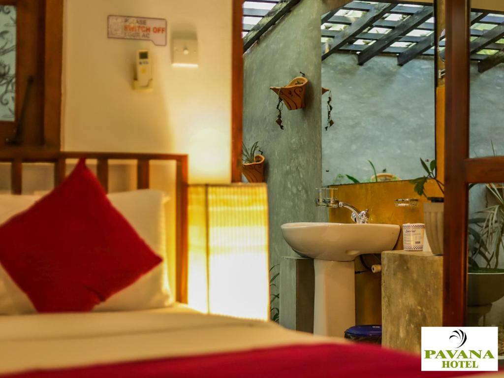 Postel nebo postele na pokoji v ubytování Pavana Hotel