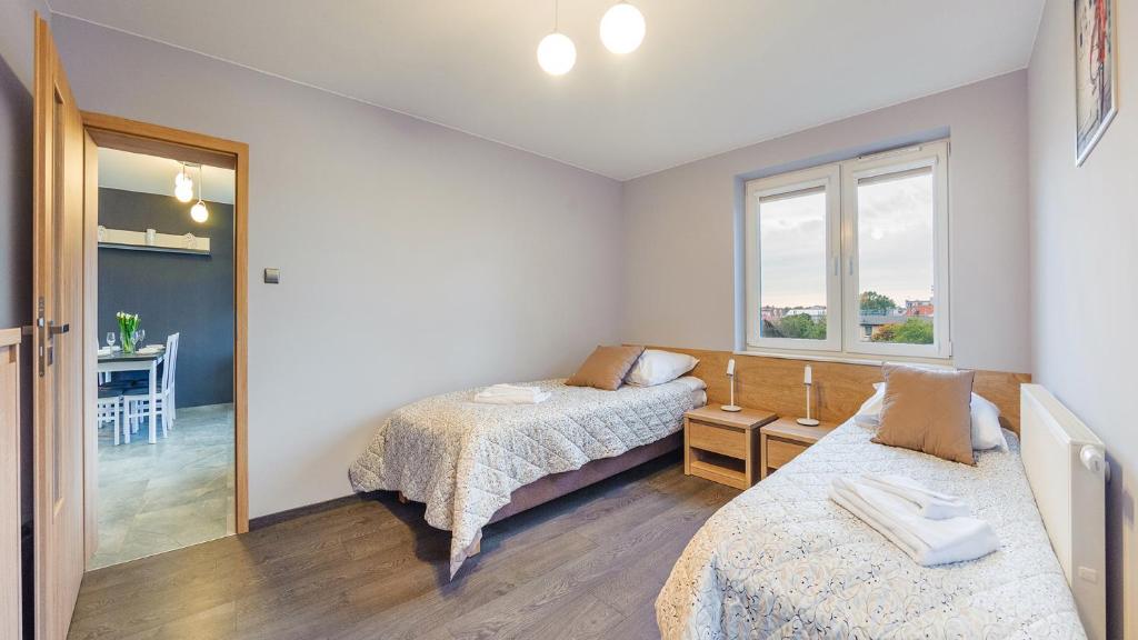 Posteľ alebo postele v izbe v ubytovaní Apartamenty Holiday City - Perłowa Przystań