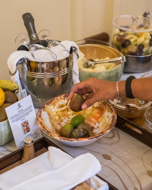 A buffet spread with fruit, bread and a chilled bottle service display.