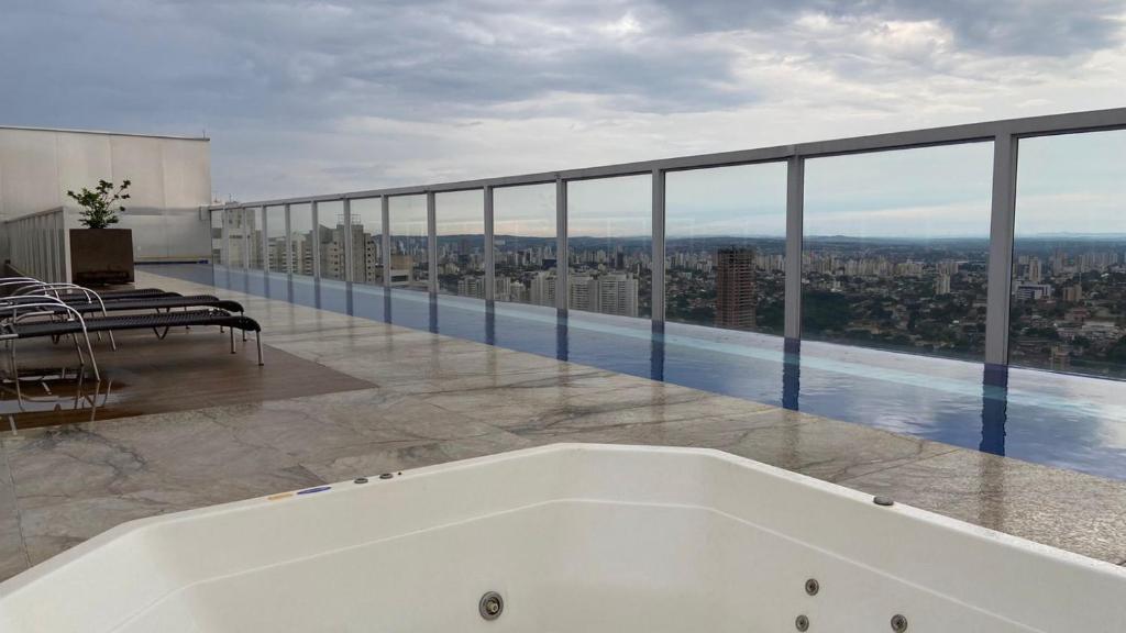 a bath tub on a balcony with a view of the city at Trend 2414 in Goiânia