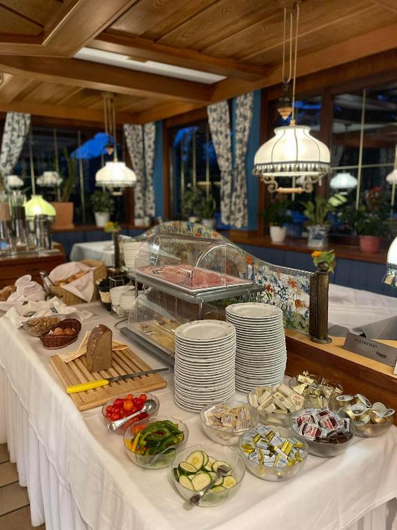 a buffet table with plates of food on it at Hotel Restaurant - Häuserl im Wald Graz in Graz