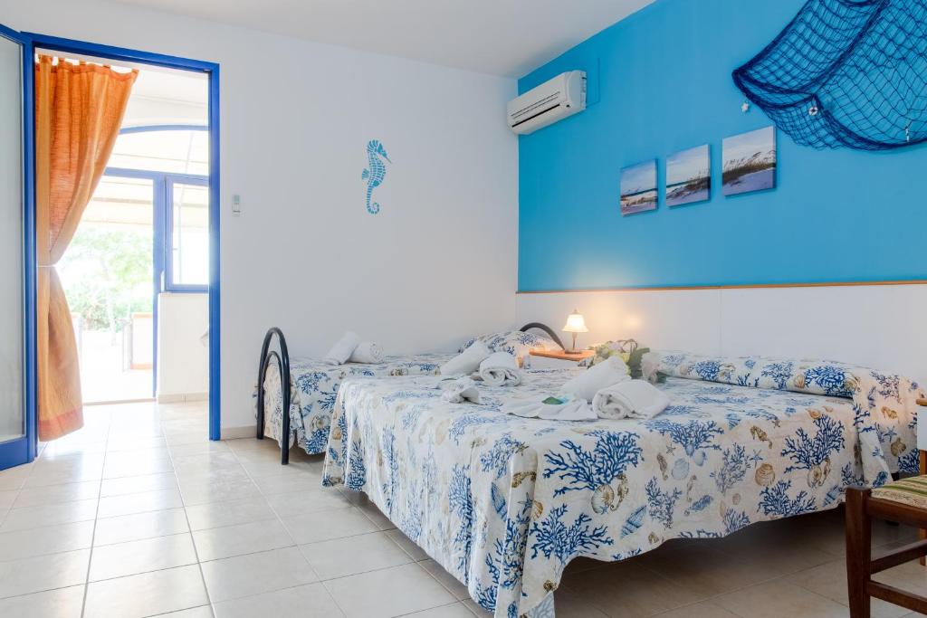 A bed or beds in a room at Scialabà Residence Salento