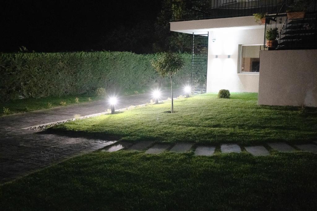 a yard at night with lights on the grass at Meteora vibes in Kalabaka