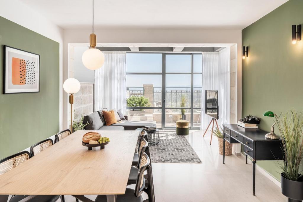 a living room with a table and a couch at Mr. Agrippa - By TLV2GO in Jerusalem