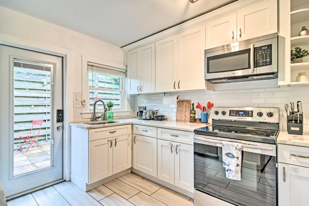 a kitchen with white cabinets and a stove top oven at Retreat Half-Mile to BeachandSiesta Key Village in Siesta Key
