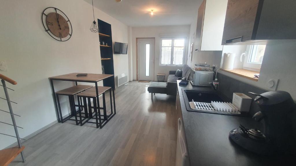 a room with a kitchen and a living room at Maison de charme pour 6 au coeur de l'Auvergne in Brassac-les-Mines