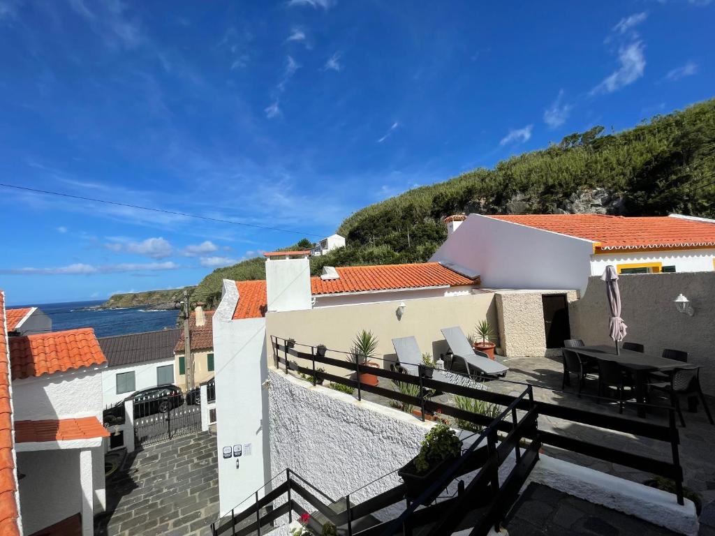 a house with a balcony with a view of the ocean at Super Mário Houses - Casa dos Moinhos in Porto Formoso