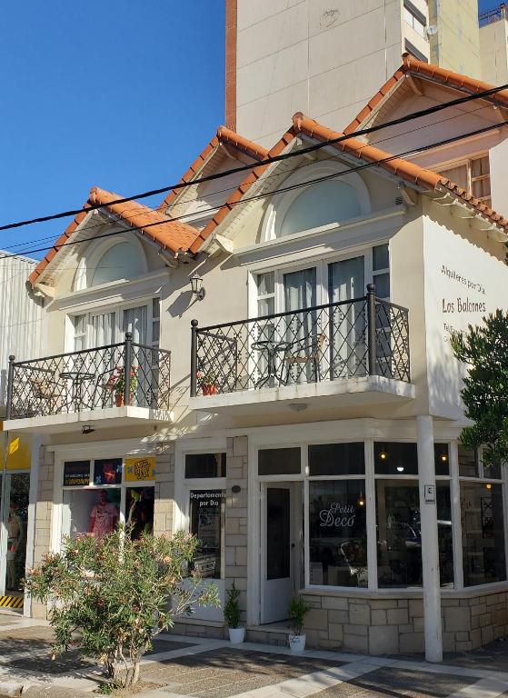 a white building with a balcony on top of it at Los Balcones Madryn in Puerto Madryn