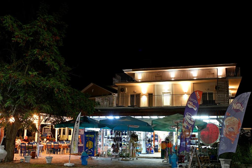 a building at night with a market in front of it at Oneiro Zois in Prinos