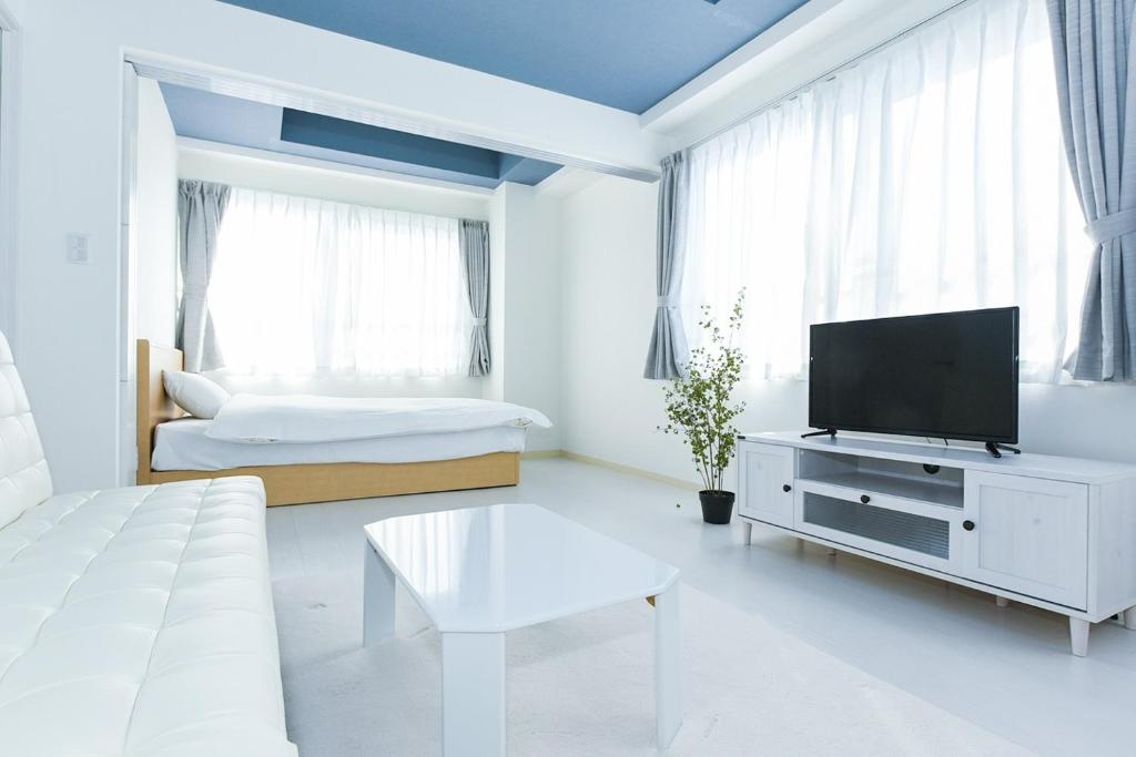 a white living room with a tv and a couch at Hills Garden Hondori - Vacation STAY 12112 in Sapporo