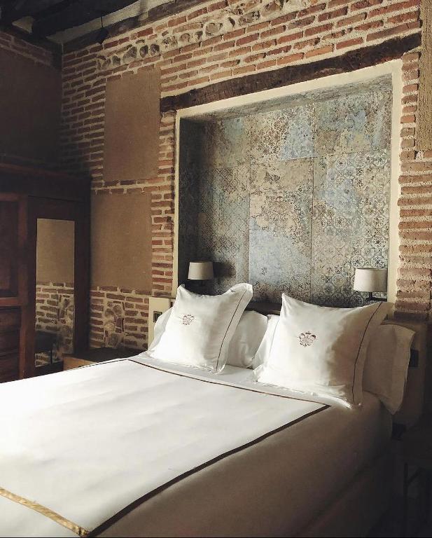 Postel nebo postele na pokoji v ubytování Hotel Boutique Casa del Comendador