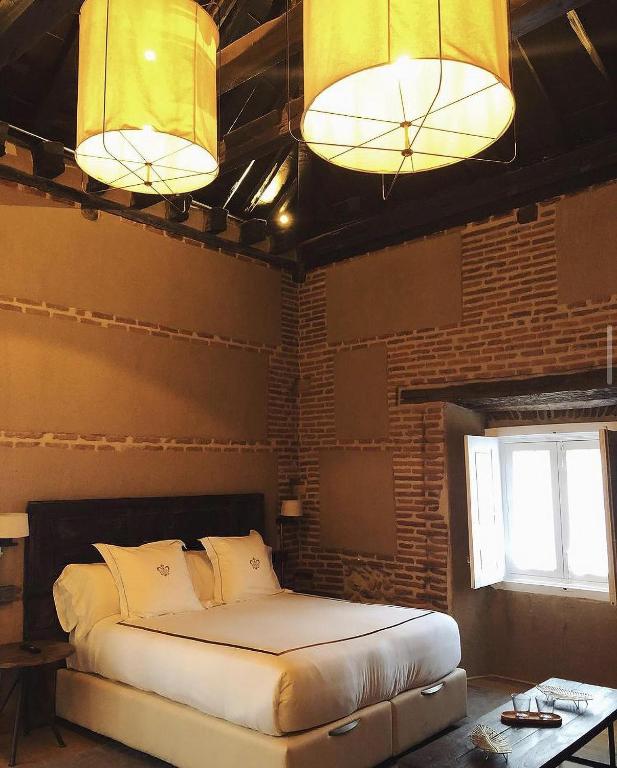 Postel nebo postele na pokoji v ubytování Hotel Boutique Casa del Comendador