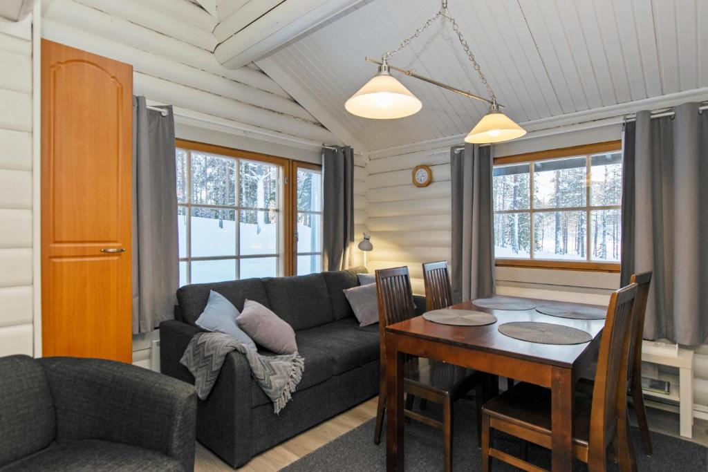 a living room with a couch and a table at Hallan Akka Apartments in Hyrynsalmi