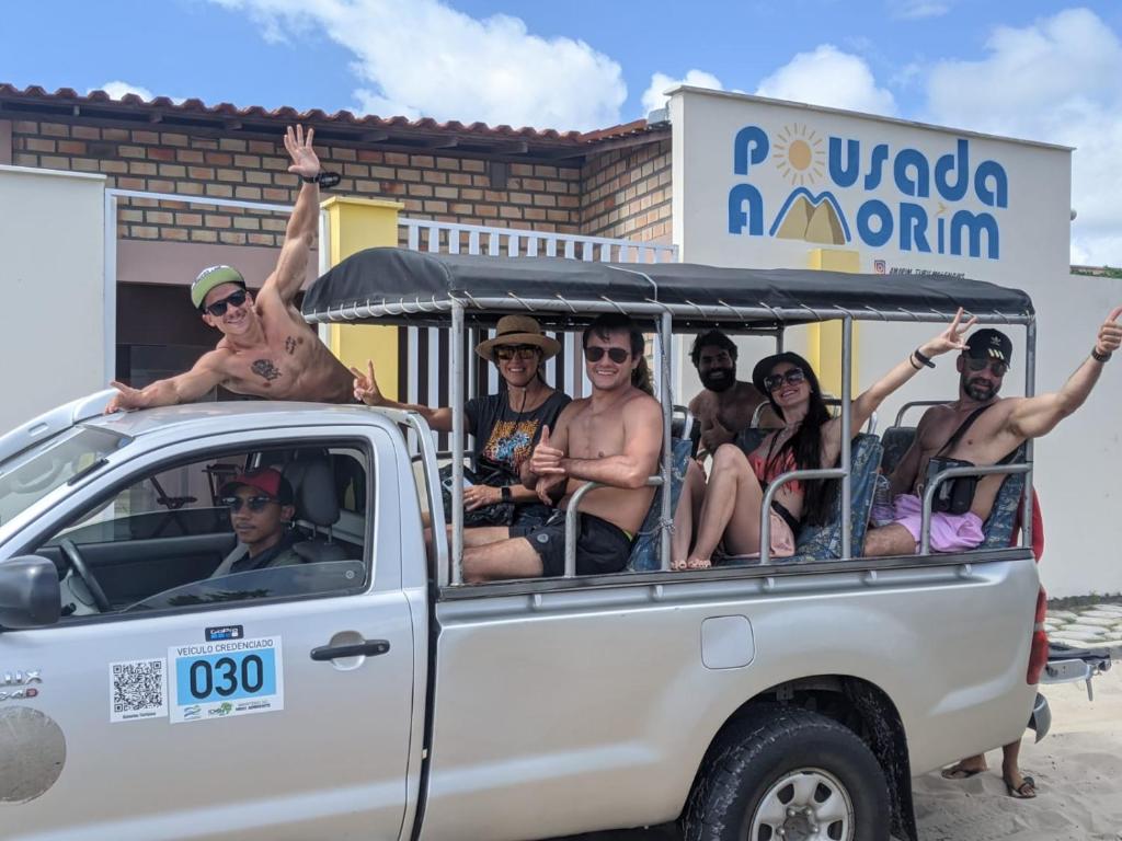 un grupo de personas sentadas en la parte trasera de un camión en POUSADA AMORIM en Santo Amaro