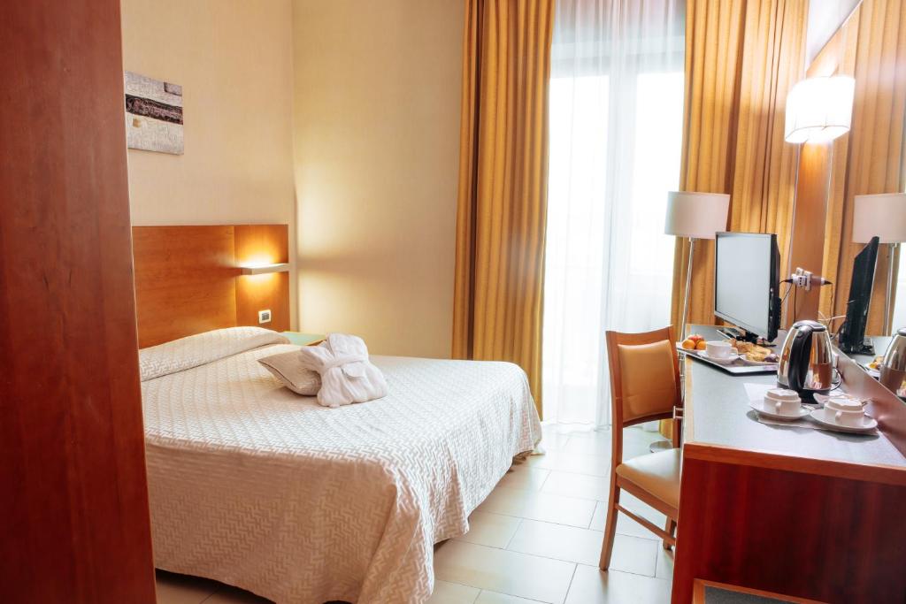 Postel nebo postele na pokoji v ubytování Hotel Amico
