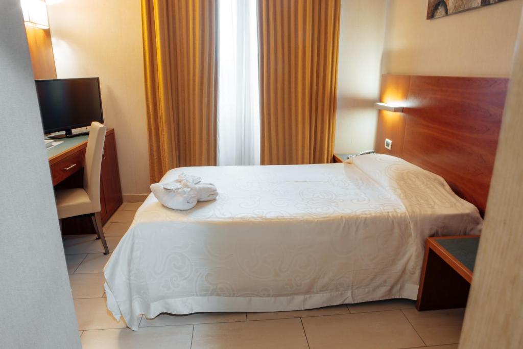 Postel nebo postele na pokoji v ubytování Hotel Amico