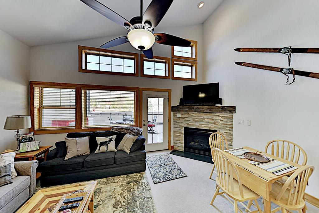 a living room with a couch and a fireplace at La Riva Del Lago 209 in Dillon
