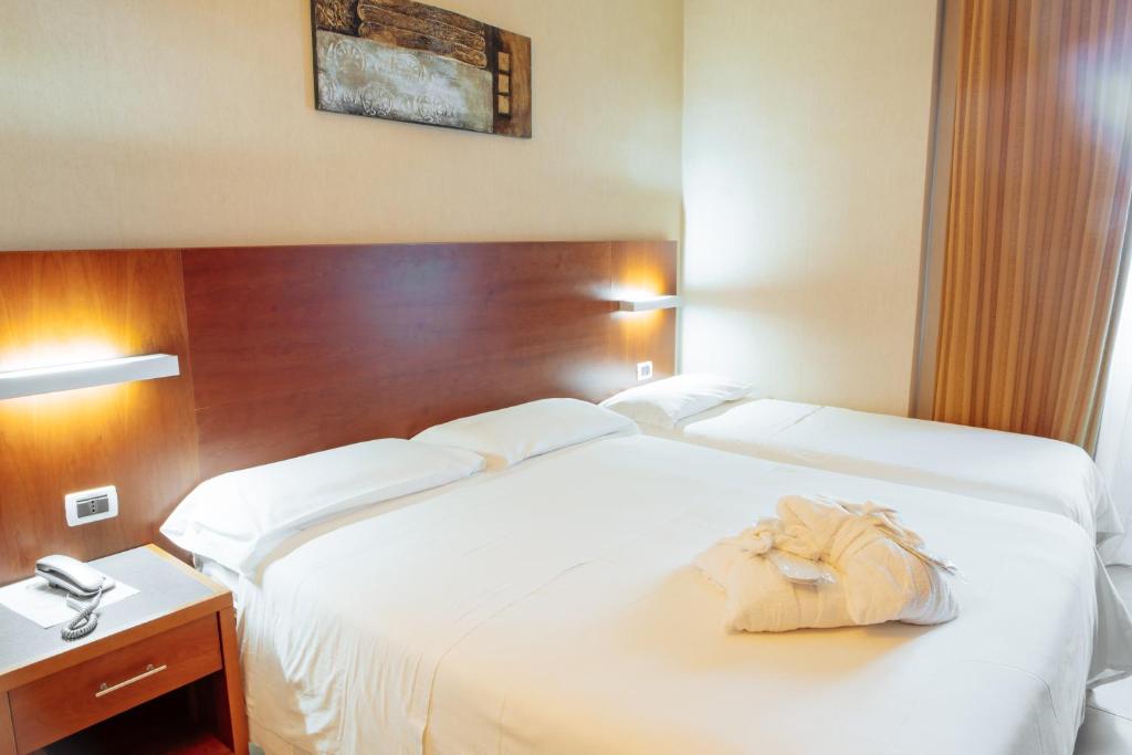 Postel nebo postele na pokoji v ubytování Hotel Amico