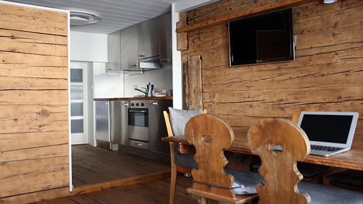 a kitchen with a desk with a laptop computer on it at Chalet Swiss Andermatt in Andermatt