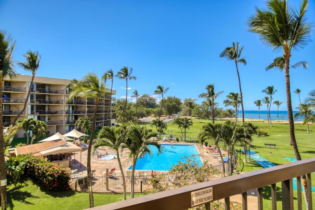 a view of the pool and beach from the balcony of a resort at Maui Sunset A317 in Kihei