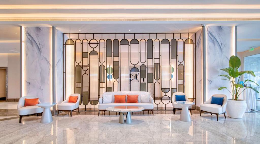a rendering of a hotel lobby with a bed and chairs at Radisson Blu Hotel & Resort, Abu Dhabi Corniche in Abu Dhabi