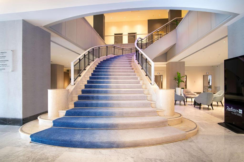 a staircase with blue steps in a building at Radisson Blu Hotel & Resort, Abu Dhabi Corniche in Abu Dhabi