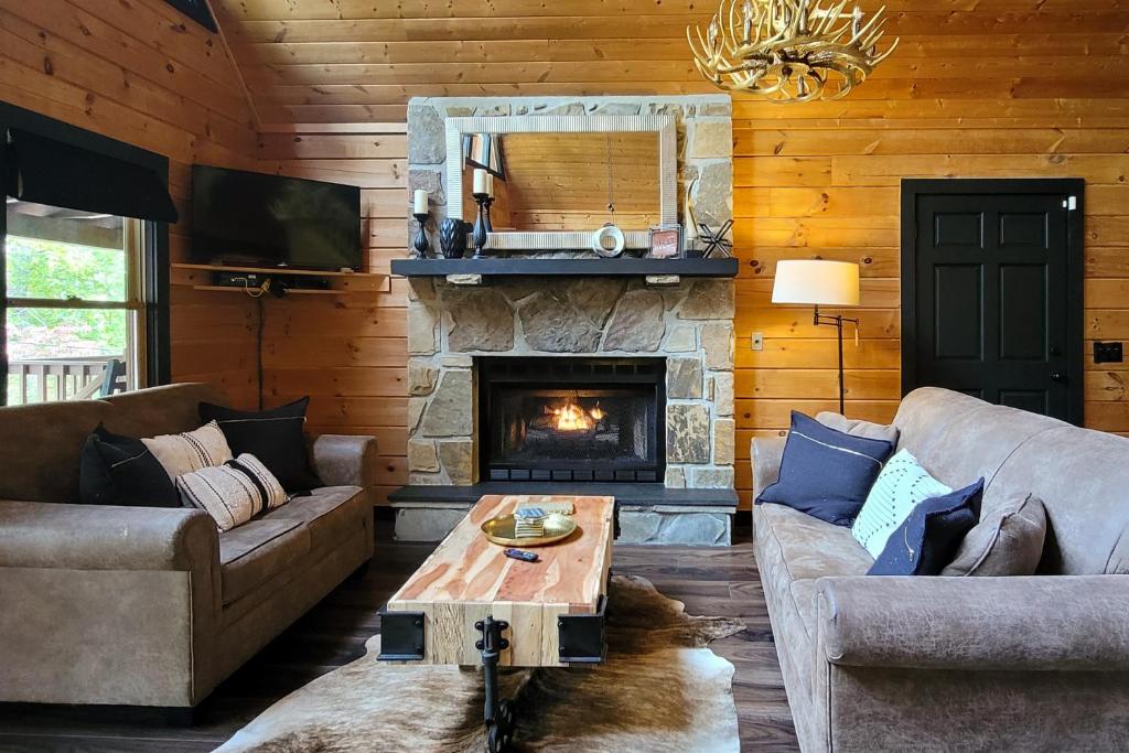 a living room with a couch and a fireplace at The Sweet Escape at Sky Harbor in Sevierville