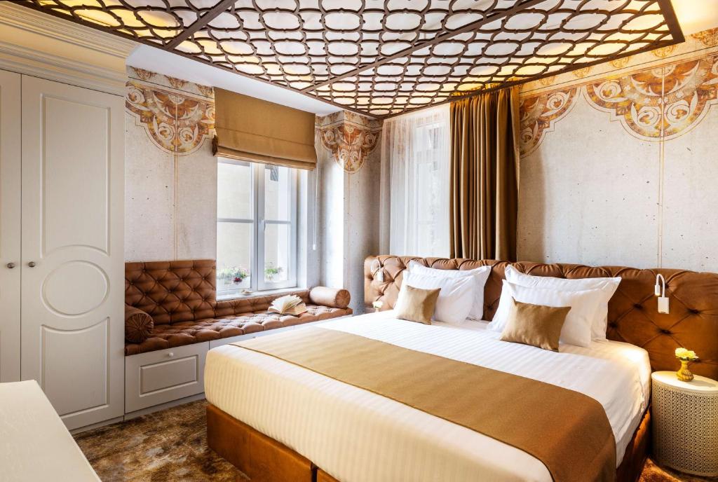 a bedroom with a large bed and a window at Art Boutique Hotel Gallery 37 Plovdiv - Superb Location in the Old Town in Plovdiv